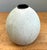 This vintage textured ceramic vase is a refined example of Mid-Century Modern design, combining sculptural simplicity with...