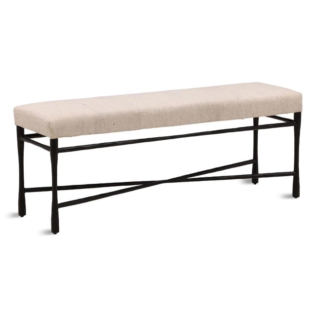 Classic and contemporary textured cream/taupe fabric upholstered bench with black hand hammered iron base. Perfect for the...