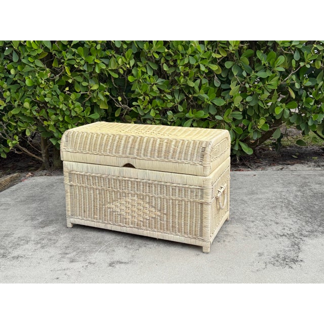 Classic Palm Beach style wicker storage trunk featuring a handwoven rattan exterior, hinged lid, and integrated side...