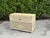 Classic Palm Beach style wicker storage trunk featuring a handwoven rattan exterior, hinged lid, and integrated side...