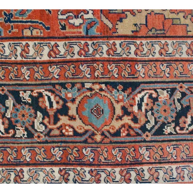 A mid-20th century Persian Sultanabad rug with a wonderful all-over floral lattice pattern on a crimson background,...