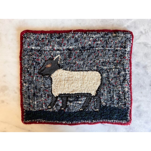 Vintage hooked wool Folk Art textile wall hanging of a sheep in beautiful flecked blue and red background and red trim....