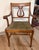 Elegant vintage Duncan Phyfe style arm chair featuring the classic lyre (harp) back design, gracefully curved arms, and...