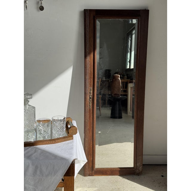 Mirror from an old wardrobe door, with an oak frame. The oak is a brown hue with a waxed patina. The rectangular, beveled...