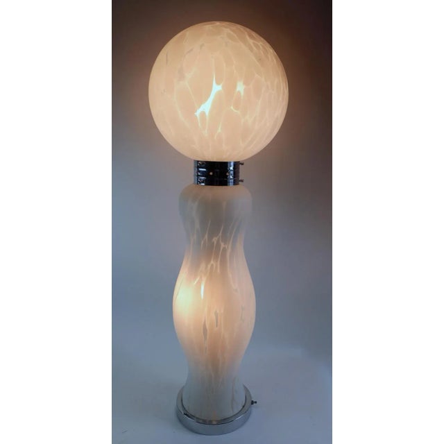 Significant Italian lamp designed by Carlo Nason for Mazzega. The ball top rests on a bright chrome color, which attaches...