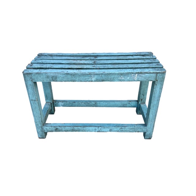 Rustic wood slatted bench painted a vivid blue with cross braces and solid construction. Cute little piece with lots of...