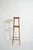 Light wood faux bamboo pedestal table, 1900s. Light wood side table resting on four faux bamboo feet joined by two belts...