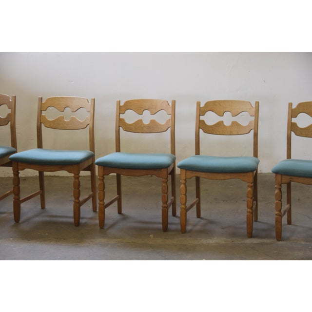 Henning Kjærnulf's striking dining chairs, crafted from oak and showcase a captivating blend of brutalist/Baroque and Mid-...