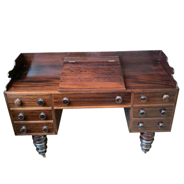 An American desk possibly used for writing with a chair area of 24"x19"x24" and a clearance of 13.25".