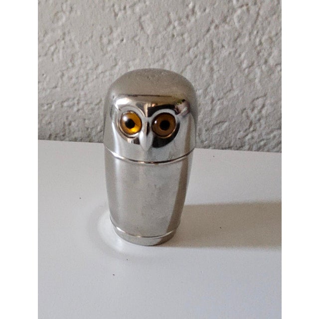 This is a mid-century German metal owl-shaped holder for nested shot glasses. It is made of metal, often stainless steel...