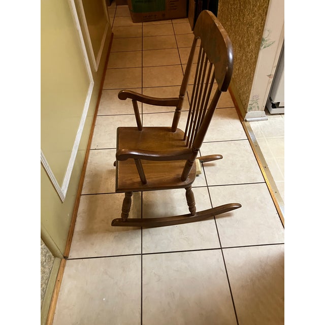 This vintage 1940s-1960s Oak Hill Furniture Company of Fitchburg, MA child's solid wood rocking chair with a German-made...