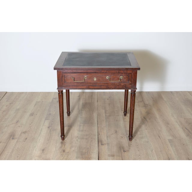 This elegant 18th-century French console table is a fine example of Louis XVI style, reflecting neoclassical elegance and...