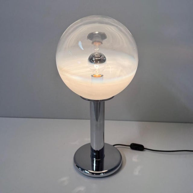 Murano table lamp by Targetti Sankey from the 1960s with a large glass globe that subtly fades to white. This Italian...
