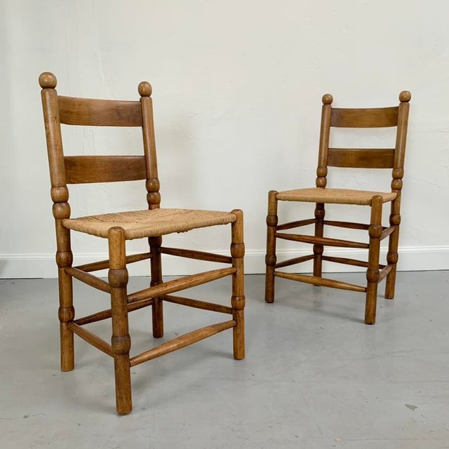 Charles Dudouyt style pair of decorative chairs, circa 1940, France. Nice original model in oak and straw. Dimensions: 88...