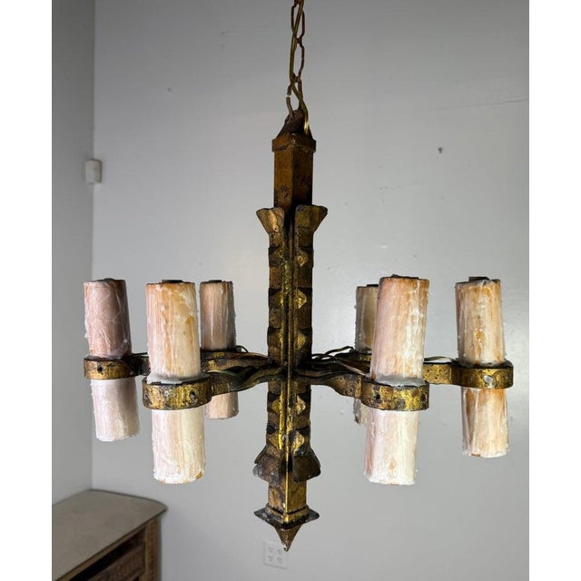 This six-light chandelier is a striking example of rustic, hand-forged craftsmanship with a bold, geometric silhouette....
