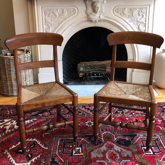 Offering a pair of antique English-style bar back chairs. These beautifully hand-constructed chairs have their original...