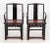 Pair of Chinese Black Lacquered Armchairs, circa 1900, with red painted seat and carved apron conjoined by box stretcher....