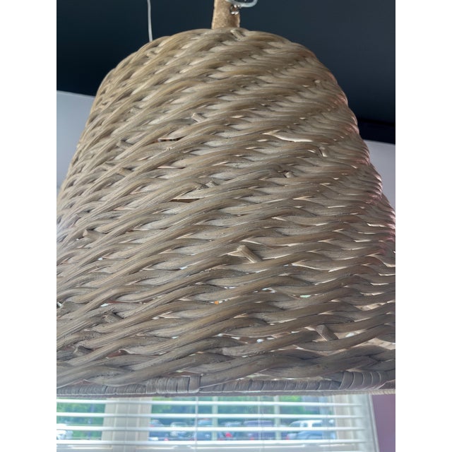 This charming wicker pendant light is a simple way to bring the coastal aesthetic into your home. The shade is wicker in a...