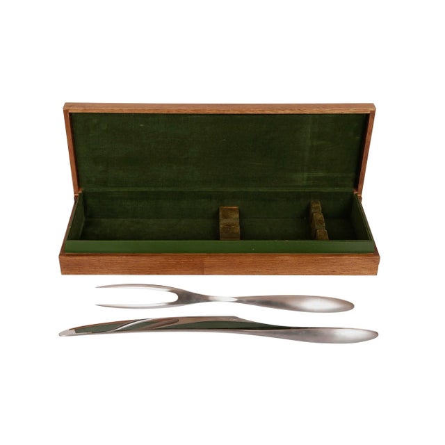 An Italian modernist stainless steel carving knife and fork set. Each is signed Chef P. Giovani and marked Stainless...