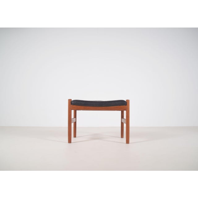 Danish stool designed by Hugo Frandsen in the 1960s. This leather-upholstered stool was manufactured by Spøttrup Møbler....