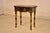 Circa 1960's hand painted side table with chinoiserie style decoration from England. The top of the table is shaped, and...
