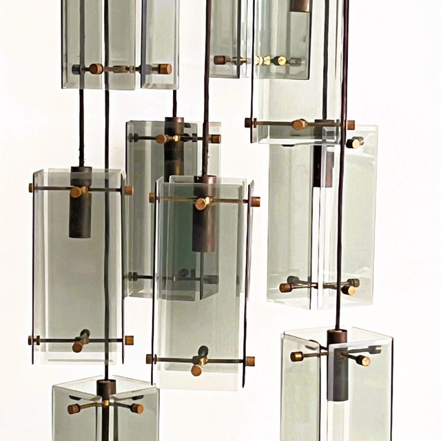 Immerse yourself in the timeless elegance of 1960s Italian design with this extraordinary pair of pendant lamps....