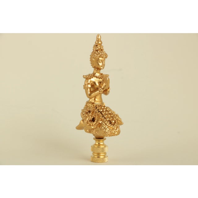 Matching pair of lamp finials crafted from lightweight meditating Buddha figures on brass hardware sized to fit a...