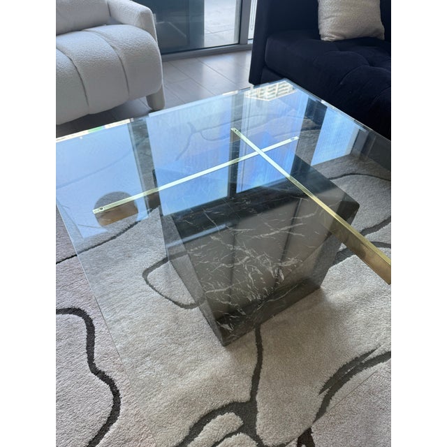 Authentic vintage Artedi Italia coffee table from the 1970s featuring a sculptural black marble pedestal base, solid brass...