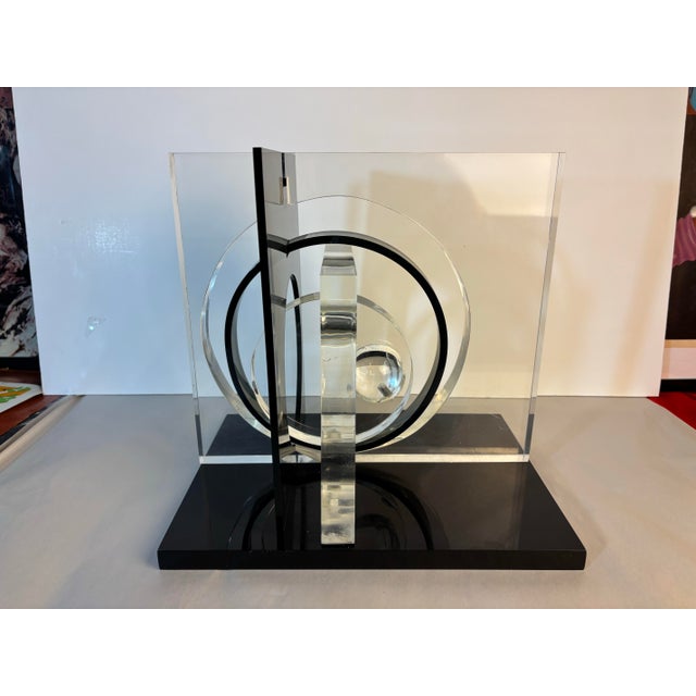 Miriam Blanc Lucite Sculpture. In shades of black and clear lucite. Nice size and scale, sits on a black lucite base.