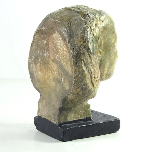 Decorative head in antique type placed on a base. It is made of painted and patinated stucco plaster. Vintage item....