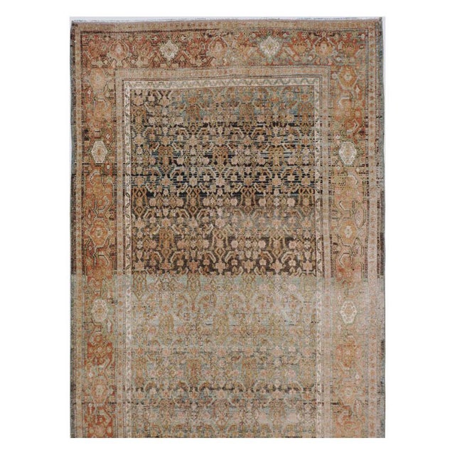 This early 20th-century Persian Senneh Malayer long runner presents a finely patterned allover composition across a muted...