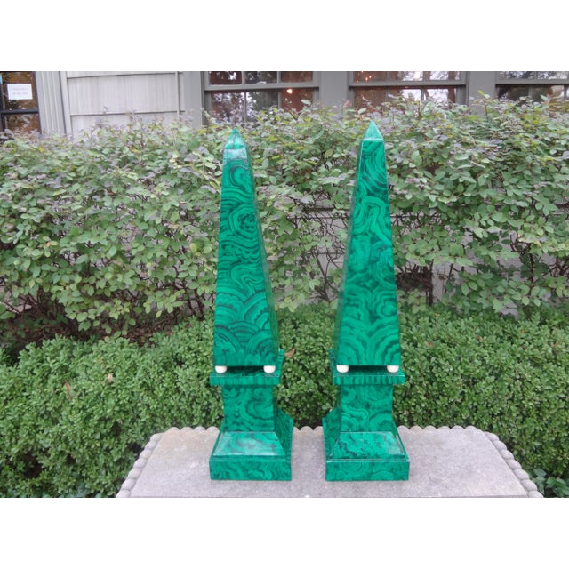 Pair of large carved wood faux Malachite Obelisks. Offered is a stunning pair of Hollywood Regency style carved wood...