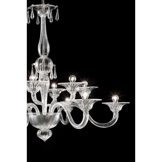 Elegant chandelier in transparent made in Murano glass and chromed metal frame. For classical and modern interiors, a...