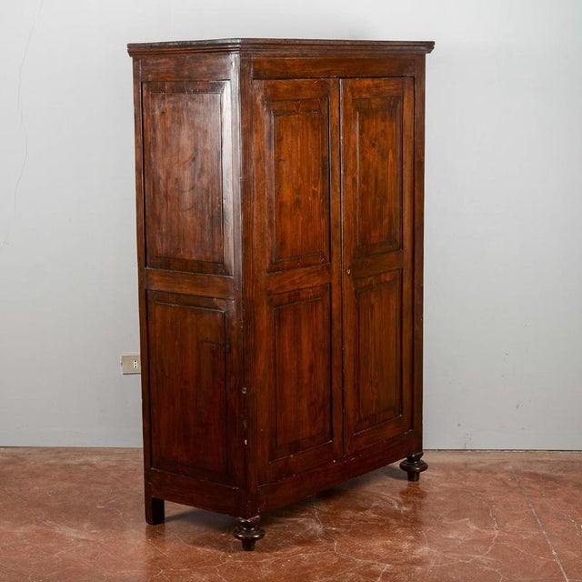 This refined antique wardrobe, dating back to the late 19th century, is a superb example of traditional wood...