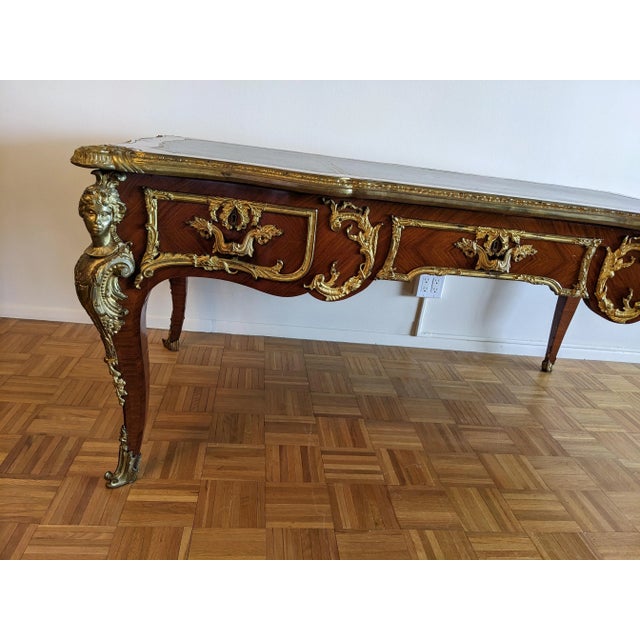 Luxuriance! An antique French bureau plat, from late 19th century, featuring ornate gilt-bronze mounts Louis XV Style...