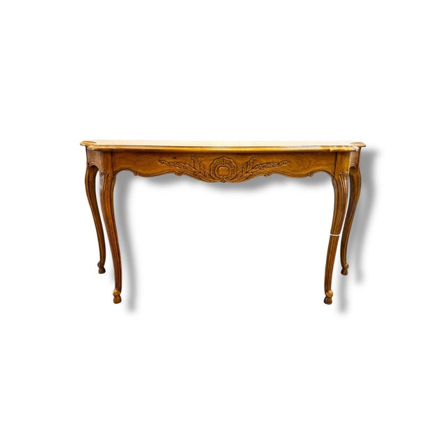 This elegant Barker Bros. console table showcases classic French Provincial styling with beautifully carved detailing,...