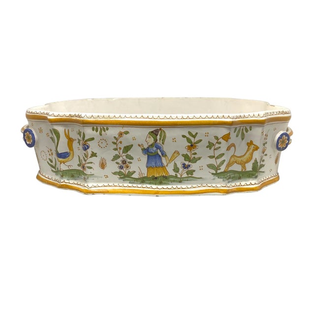 A fine French 19th century polychrome Faience jardiniere painted in pastel tones with figures and animals and flowers. The...