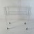 A two tiered bar cart in in acrylic glass with shelves in glass. In very good condition and very stabile. It also is easy...