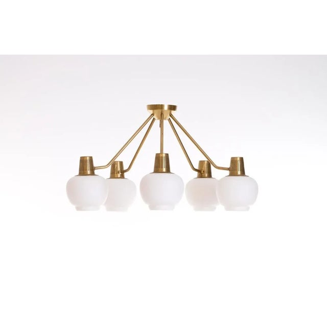 Designed by Hans Bergström. Solid brass and opaline shades. Produced by Ateljé Lyktan in Åhus, Sweden, 1950s. This piece...