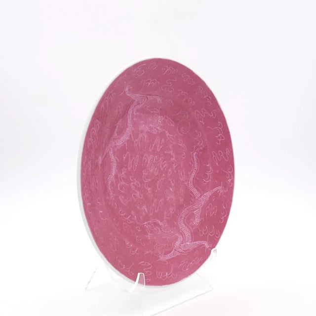 A Chinese pink low bowl decorated with dragons, circa 1880.