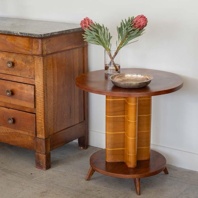 Beautiful Art Deco wood gueridon table from France, 1930s. Bookmatched walnut circular top on column stem with contrasting...
