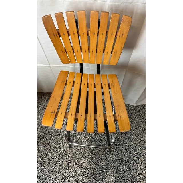 Mid Century Modern Arthur Umanoff slatted wood swivel barstool. Made in Yugoslavia. Circa 1960s. Measures 41” h x 17” w x...