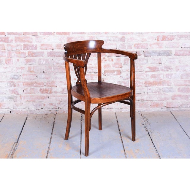 This elegant Art Deco armchair originates from Slovakia from the early 20th century. It is crafted from solid beech wood...