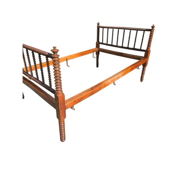 An authentic 19th-century antique Jenny Lind full-size spool bedstead, showcasing continuous, high-relief lathe-turned...
