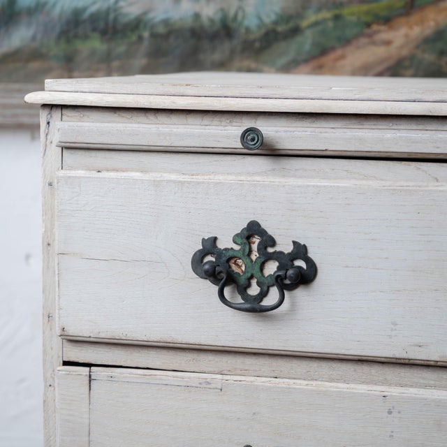 A Georgian oak chest with brushing slide, circa 1740, with three long drawers and a brushing slide above the drawer bank....
