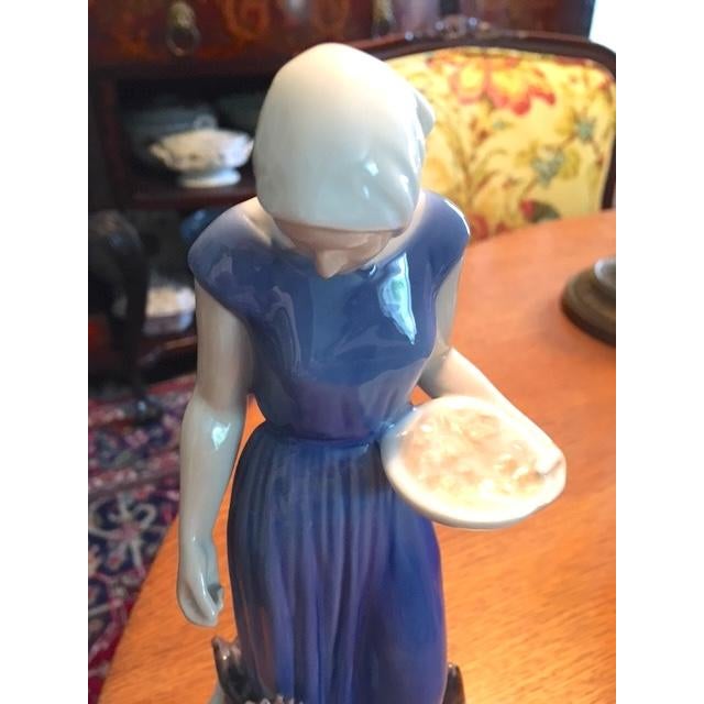 Very lovely Bing & Grondahl porcelain figurine. Look at these wonderful chickens! The graceful maiden has a blue dress on...