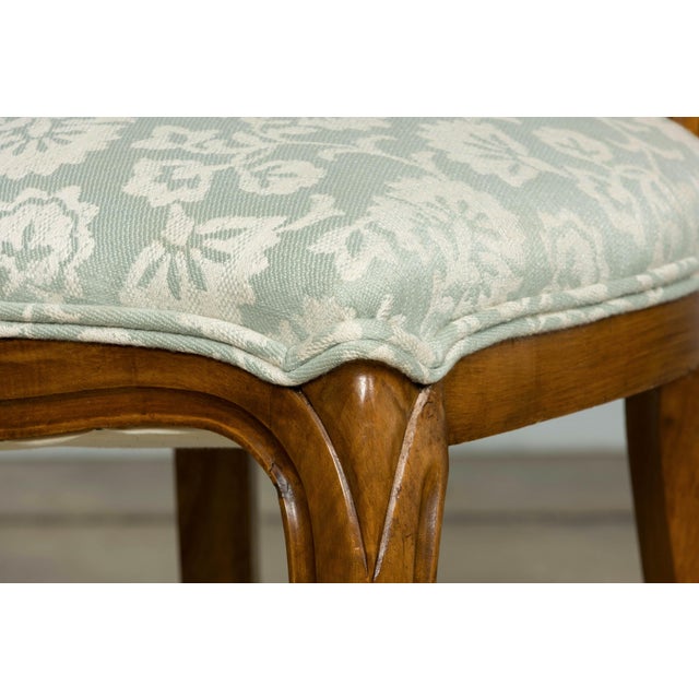 A set of ten late 19th-century French Louis Philippe walnut dining chairs, sourced in Paris, France. The chairs feature...