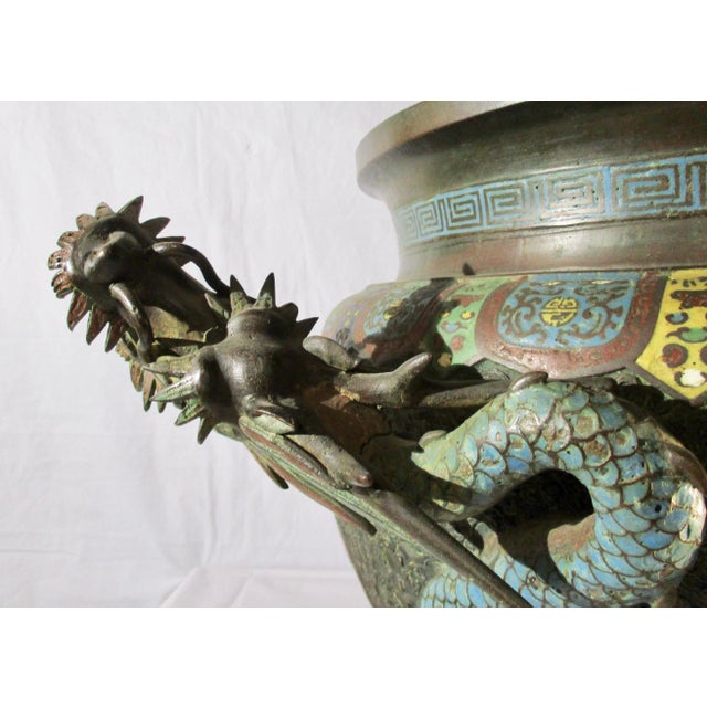 Dragon wrapped Bronze urn or incense burner. Champleve enamel to highlight dragon and lighting across a field of small...