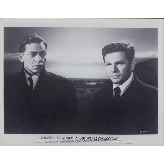 Original black-and-white lobby card for the film "Humoresque" (1946) featuring John Garfield and Oscar Levant. This...