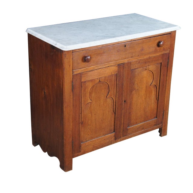 An Antique Victorian Marble-Top Washstand, circa 1867–1880. Originally part of a bedroom suite for holding a basin and...